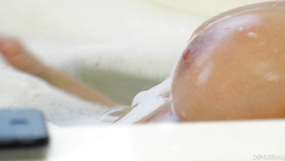 Katie Morgan is playing with her big tits and pussy in the bathtub