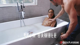 Ebony Kira Noir is sucking two white cocks in the bathtub