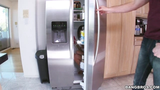 Amara Romani in her underwear cleaning the fridge