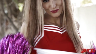 Moka Mora in cheerleader uniform flashes her panties outdoors