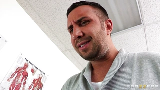 Dana Vespoli in a glasses maintains eyecontact while blowing