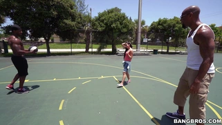 Michelle Martinez playing basketball with three black muscle dudes