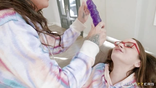 Hazel Moore and Suttin in glasses share the dildo
