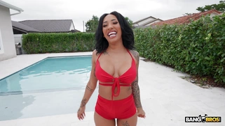 Kona Jade shows off her ass and tits poolside
