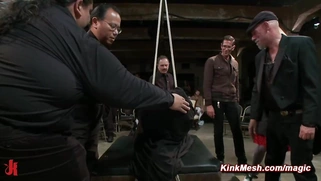 Tied and shrouded in a black sheet