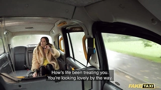 Ava Austin is riding a large black dildo in the back seat of a fake taxi