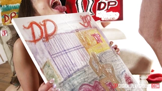 Gia Paige holds the painting and Danny D shoots cum on it