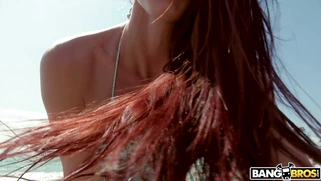 Redhead Aidra Fox has fun on the beach